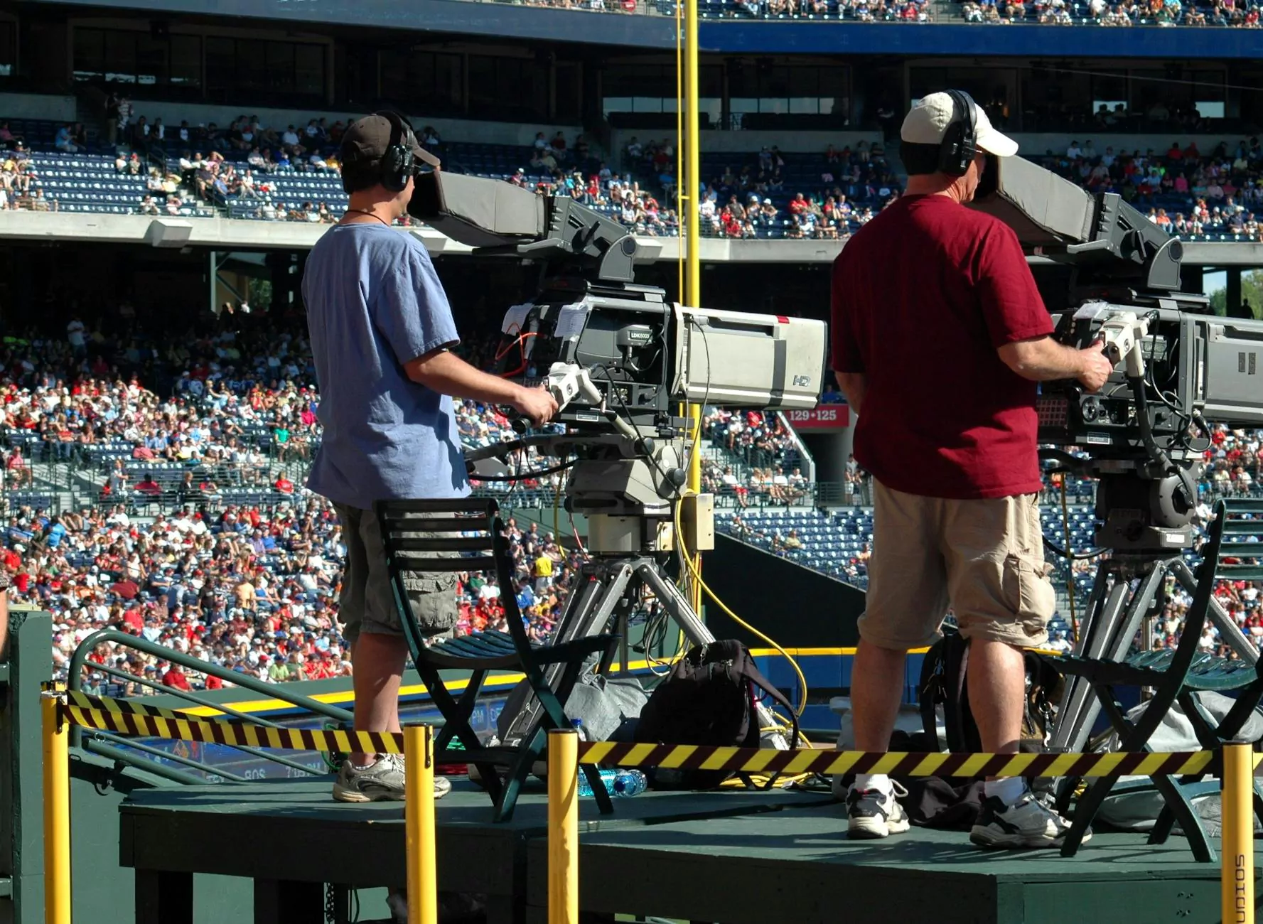 Television camera operators covering an outdoor event